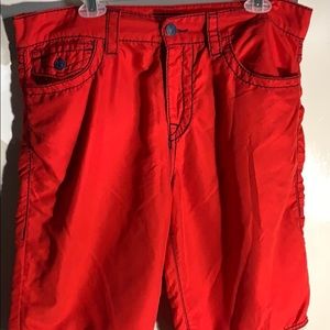 Red True Religion swim trunks.